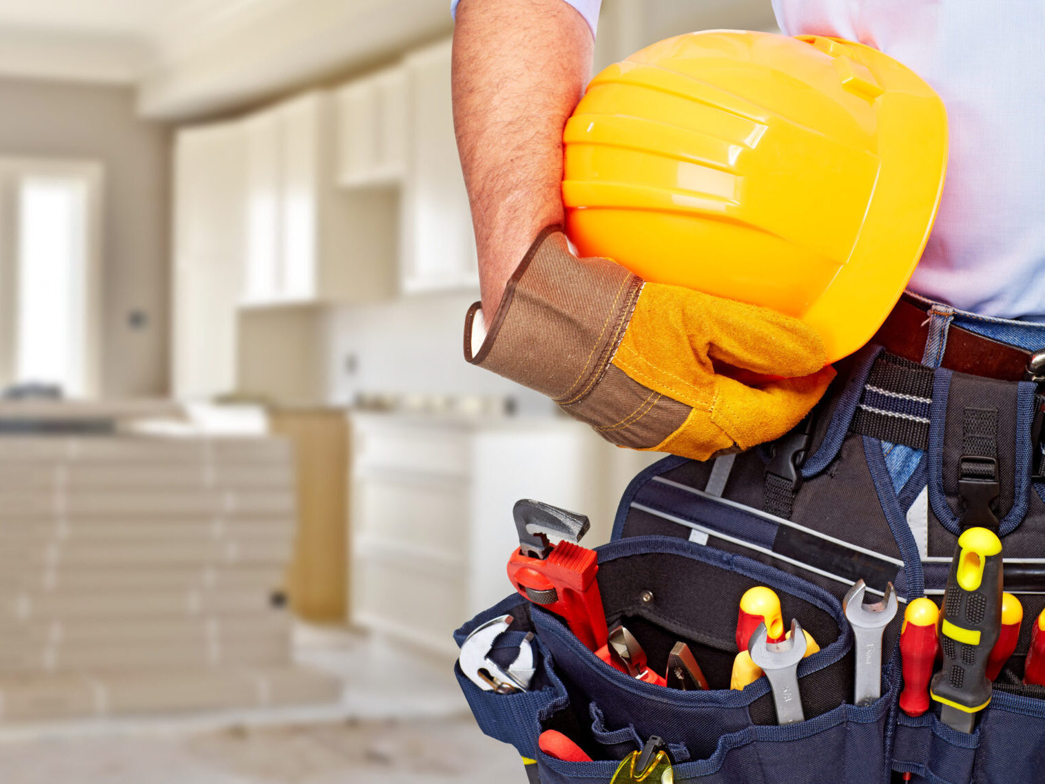 Builder handyman with construction tools.